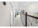 Bright upstairs hallway with white doors, carpet, and access to a balcony with neighborhood views at 1856 Cross Prairie Pkwy, Kissimmee, FL 34744