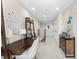 Upstairs hallway featuring a desk area with ladder shelves, and a view of the staircase at 1856 Cross Prairie Pkwy, Kissimmee, FL 34744