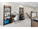 Upstairs hallway featuring a desk area with ladder shelves, and view of carpeted staircase at 1856 Cross Prairie Pkwy, Kissimmee, FL 34744