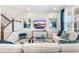 Bright living room featuring a modern entertainment center, cozy seating, and stylish decor at 1856 Cross Prairie Pkwy, Kissimmee, FL 34744