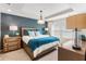 Beautiful main bedroom with tray ceilings, stylish lighting, and an eye-catching accent wall at 1856 Cross Prairie Pkwy, Kissimmee, FL 34744