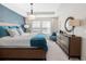 A spacious main bedroom features a tray ceiling, natural light, and modern decor elements at 1856 Cross Prairie Pkwy, Kissimmee, FL 34744