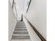 Carpeted staircase with dark wood handrail leading to the upper level of the home at 1856 Cross Prairie Pkwy, Kissimmee, FL 34744
