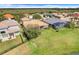 Aerial view of backyard with screen patio, pool, and lush green grass at 1950 Windward Oaks Ct, Kissimmee, FL 34746