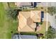 Aerial view of home with tile roof, green lawn, and paver driveway at 1950 Windward Oaks Ct, Kissimmee, FL 34746