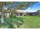 Large backyard with a screen patio and lush green grass at 1950 Windward Oaks Ct, Kissimmee, FL 34746