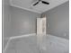 This bedroom features a ceiling fan and pristine white tile flooring at 1950 Windward Oaks Ct, Kissimmee, FL 34746