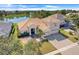 An inviting two-story home with a tile roof and a three-car garage is situated with views of a tranquil lake at 1950 Windward Oaks Ct, Kissimmee, FL 34746