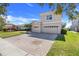A well-maintained two-story home featuring a three-car garage and a paver driveway at 1950 Windward Oaks Ct, Kissimmee, FL 34746