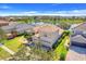 An inviting two-story home with a tile roof and a three-car garage is situated with views of a tranquil lake at 1950 Windward Oaks Ct, Kissimmee, FL 34746