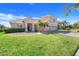 Charming home with a well-manicured lawn, mature landscaping, and a spacious three-car garage at 1950 Windward Oaks Ct, Kissimmee, FL 34746