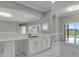 Open-concept kitchen with island, marble floors, and stunning lake views at 1950 Windward Oaks Ct, Kissimmee, FL 34746