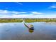 Scenic lake view with a charming gazebo and a winding wooden boardwalk leading to it at 1950 Windward Oaks Ct, Kissimmee, FL 34746
