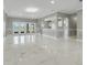 Spacious living room with marble floors, abundant natural light, and doors leading to the outdoors at 1950 Windward Oaks Ct, Kissimmee, FL 34746