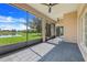Screened-in patio with stone floors offering views of the backyard and pond at 1950 Windward Oaks Ct, Kissimmee, FL 34746