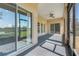 Screened-in patio with stone floors offering views of the backyard and pond at 1950 Windward Oaks Ct, Kissimmee, FL 34746
