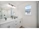 Modern bathroom with double vanity, sleek fixtures, and glass enclosed shower at 1975 Peel Ave, Orlando, FL 32806