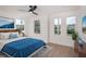 Inviting bedroom with hardwood floors, three large windows, and soothing blue accents at 1987 Peel Ave, Orlando, FL 32806