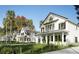Quaint two-story white homes with black shutters, covered porches, and tropical landscaping at 1987 Peel Ave, Orlando, FL 32806