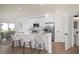 Bright, modern kitchen with white cabinetry, stainless steel appliances, and a stylish island with seating at 1987 Peel Ave, Orlando, FL 32806