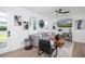Bright living room with hardwood floors, grey sofa, modern art, and plenty of natural light at 1987 Peel Ave, Orlando, FL 32806