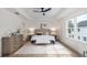 Serene main bedroom with tray ceilings, neutral tones, hardwood floors and generous natural light at 1987 Peel Ave, Orlando, FL 32806