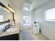 Bright bathroom with double sink vanity, stone countertops, and decorative lighting at 2121 Knollview Ct, Oviedo, FL 32765