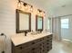 Bathroom features a double sink vanity, quartz countertops, rustic mirrors, and hexagon tile flooring at 2121 Knollview Ct, Oviedo, FL 32765