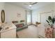 Neutral Bedroom room featuring a crib, changing table, accent furniture, and a ceiling fan at 2121 Knollview Ct, Oviedo, FL 32765