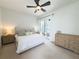 Bright, neutral bedroom featuring a king bed, ceiling fan, and access to the outdoor pool area at 2121 Knollview Ct, Oviedo, FL 32765