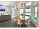Sun-drenched dining area with round table, seating for six, and views of the pool and backyard at 2121 Knollview Ct, Oviedo, FL 32765