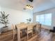 Dining room features hardwood floors, modern light fixture, and a neutral color palette at 2121 Knollview Ct, Oviedo, FL 32765
