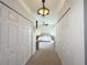 Hallway with carpeted flooring, white doors, and a light fixture, leading to a bedroom at 2121 Knollview Ct, Oviedo, FL 32765
