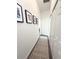 Hallway with dark wood-look floors, white walls, and framed photos at 2121 Knollview Ct, Oviedo, FL 32765
