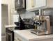 Close-up of kitchen countertop featuring stainless steel espresso machine and modern appliances on quartz countertops at 2121 Knollview Ct, Oviedo, FL 32765