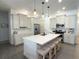 Modern kitchen with white cabinets, stainless steel appliances, a large island, and stylish pendant lighting at 2121 Knollview Ct, Oviedo, FL 32765