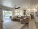 Open-concept living room and kitchen area with stainless appliances, ample seating, and natural light from the pool at 2121 Knollview Ct, Oviedo, FL 32765