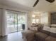 Comfortable living room featuring a sliding glass doors that offer a view of the screened in pool at 2121 Knollview Ct, Oviedo, FL 32765