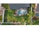 A bird's eye view of a screened-in pool and spa, surrounded by lush greenery and palm trees at 2121 Knollview Ct, Oviedo, FL 32765