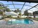 Screened-in pool area with a jacuzzi and an umbrella to provide shade while relaxing outdoors at 2121 Knollview Ct, Oviedo, FL 32765