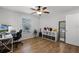 Well-lit bedroom with laminate floors and a desk for a home office at 2469 Dartmouth Rd, Deland, FL 32724