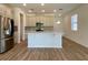 Open kitchen featuring stainless steel appliances, a large island, and modern finishes at 2668 Spider Lily Ct, Clermont, FL 34711
