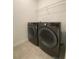 Laundry area featuring a large washer and dryer with storage shelves at 2668 Spider Lily Ct, Clermont, FL 34711
