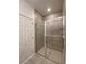 Tiled shower with glass doors in the bathroom at 2668 Spider Lily Ct, Clermont, FL 34711