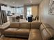 Open-concept living area showcasing a comfortable sectional sofa, dining area, and modern kitchen at 272 Cedar Bark Ln, Sanford, FL 32771