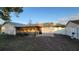 Large backyard featuring a screened-in patio and a privacy fence, creating a serene and secluded outdoor space at 272 Loma Bonita Dr, Davenport, FL 33837