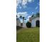 Manicured lawn next to the home, featuring a white fence and lush green landscaping at 272 Loma Bonita Dr, Davenport, FL 33837