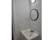 Bathroom featuring a round mirror and a vanity with a white sink at 272 Loma Bonita Dr, Davenport, FL 33837
