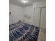 Bedroom with a blue decorative rug and a double door closet at 272 Loma Bonita Dr, Davenport, FL 33837