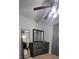 Bedroom featuring wooden floors, fan, dresser, and mirrored closet at 272 Loma Bonita Dr, Davenport, FL 33837